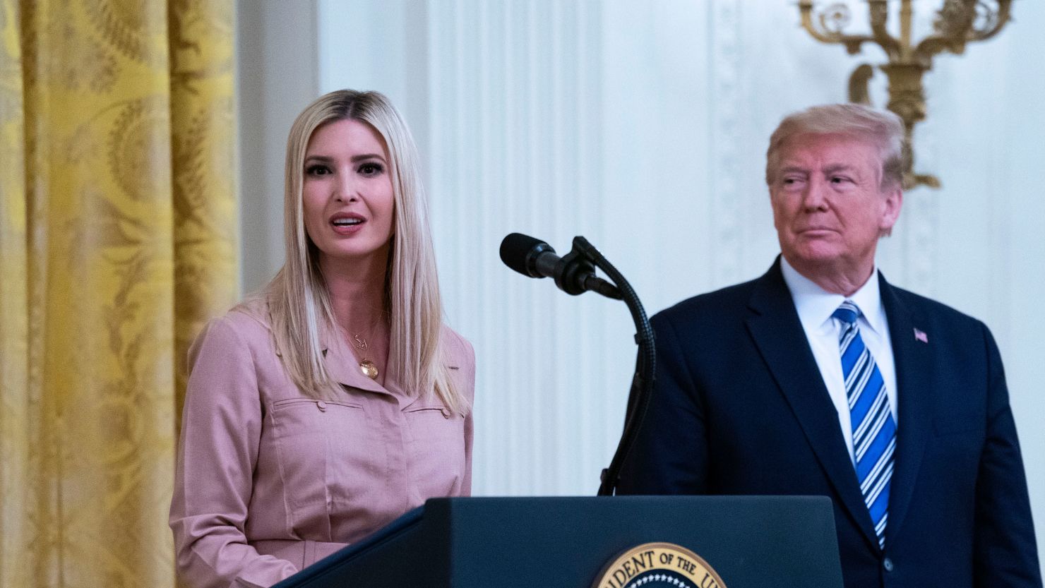President Donald Trump watches his daughter Ivanka Trump, address an event in the East Room of the White House in Washington, April 28, 2020.