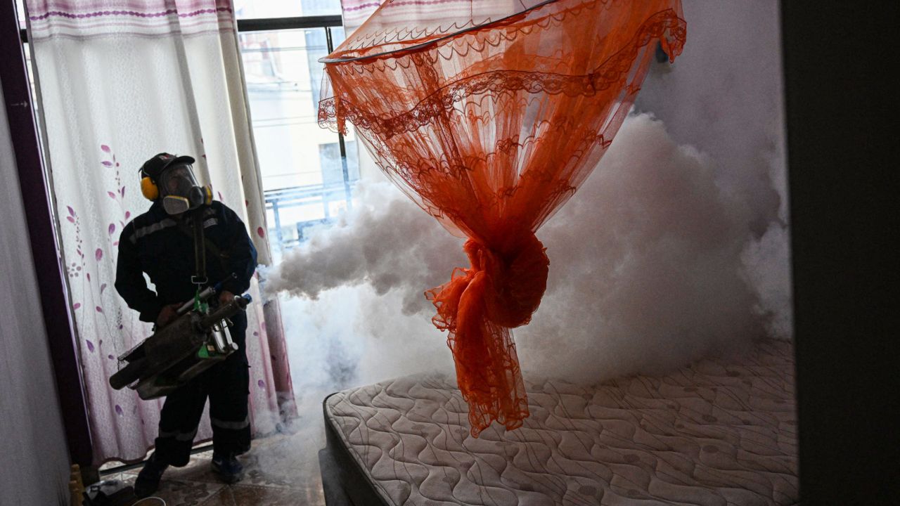 A worker fumigates a house against the Aedes aegypti mosquito to prevent the spread of dengue fever in a neighborhood in Piura, northern Peru, on June 11, 2023.