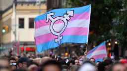 A person holds a transgender pride flag as people gather on Christopher Street outside the Stonewall Inn for a rally to mark the 50th anniversary of the Stonewall Riots in New York, June 28, 2019. - The June 1969 riots, sparked by repeated police raids on the Stonewall Inn -- a well-known gay bar in New York's Greenwich Village -- proved to be a turning point in the LGBTQ community's struggle for civil rights. (Photo by ANGELA WEISS / AFP)        (Photo credit should read ANGELA WEISS/AFP via Getty Images)