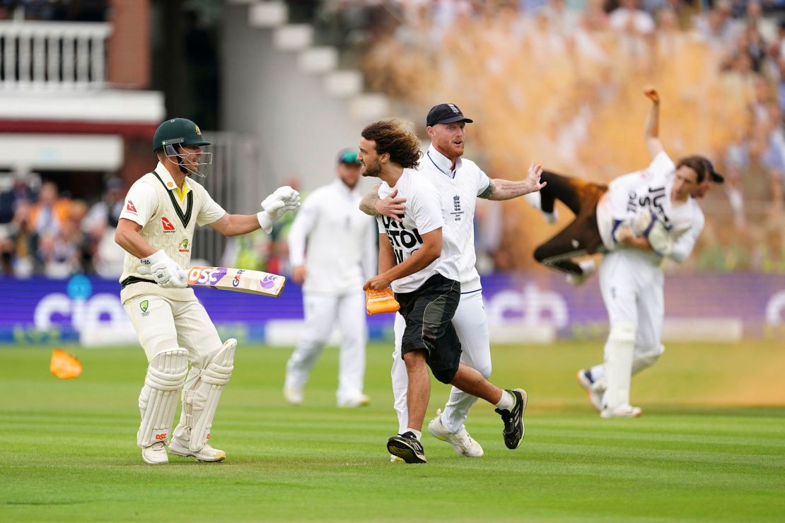 England's Ben Stokes grabs a Just Stop Oil protestor, during day one of the second Ashes Test cricket match at Lord's Cricket Ground, London, England, Wednesday, June 28, 2023.