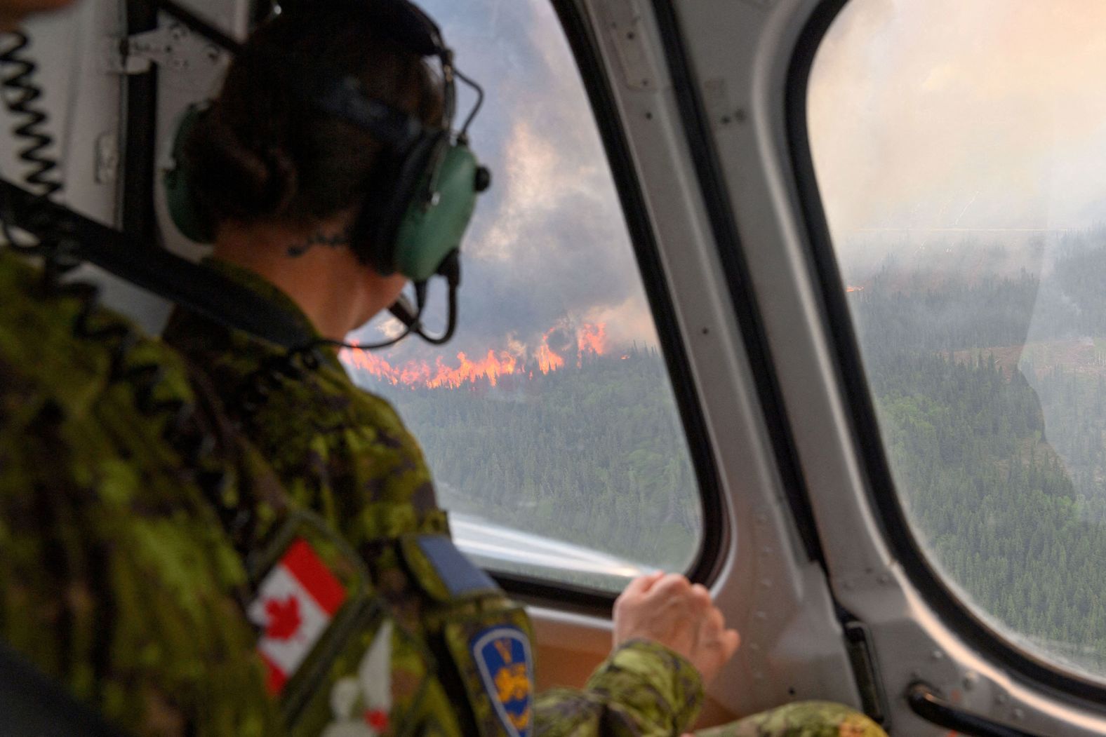 A Canadian soldier flies over a wildfire near Mistissini, Quebec, on June 12.