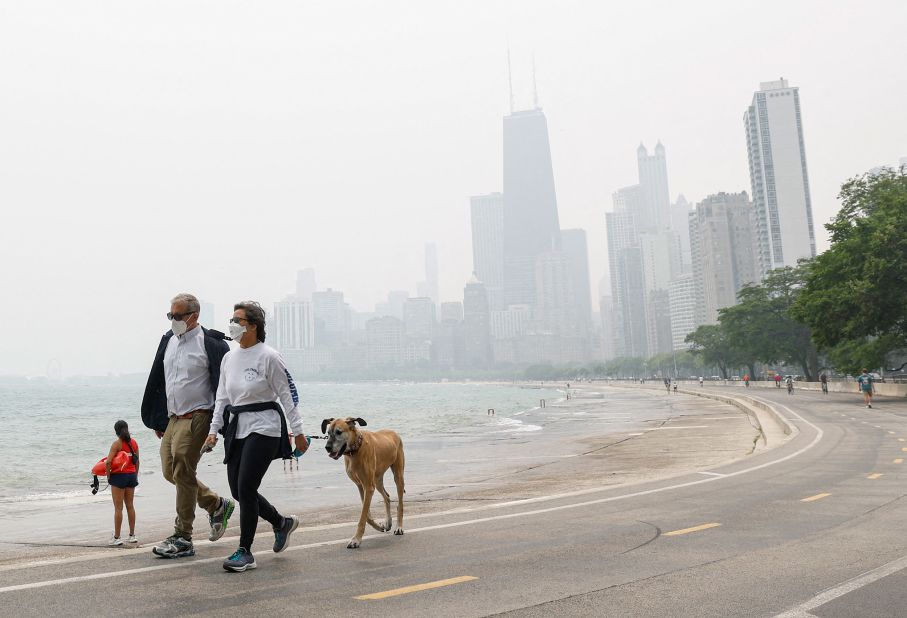 People in Chicago walk along the shoreline of Lake Michigan on June 27.