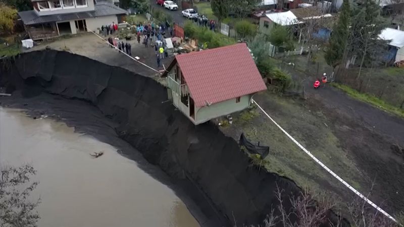 House wobbles on cliff after flooded river destroys foundation | CNN