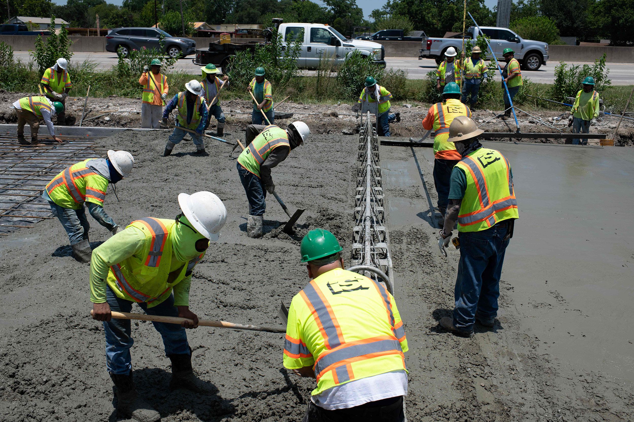 Construction crews work to repair a Houston road that was damaged by the extreme heat.