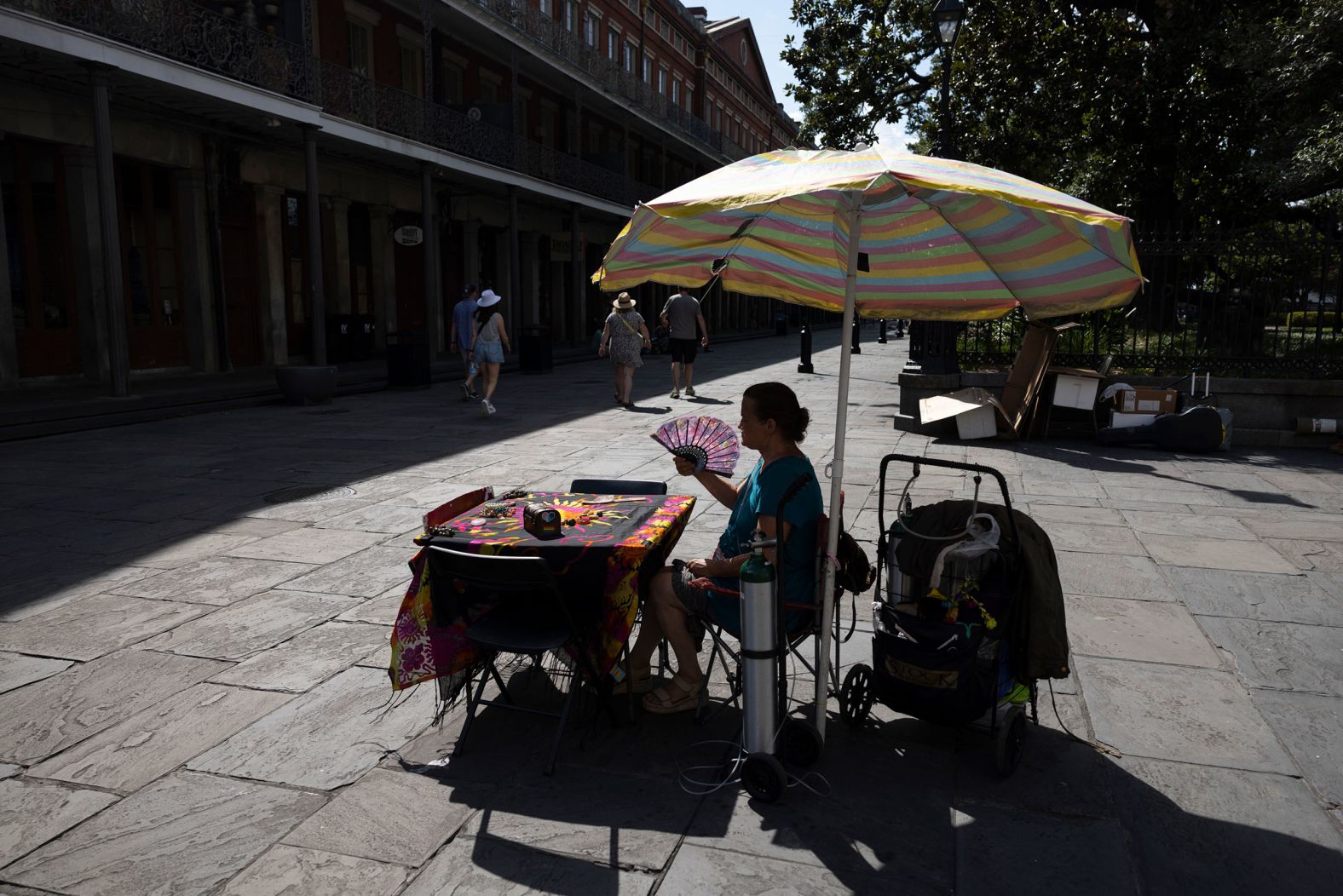 Regina "Mama Cat" Rhodes fans herself at her tarot card table in New Orleans on June 27.