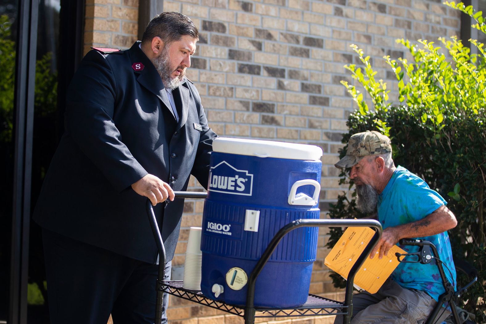 A cooler filled with ice water is wheeled outside a Salvation Army shelter in Conroe, Texas, on June 27.