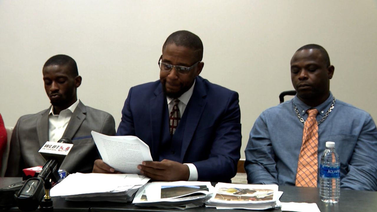 Michael Jenkins, left, attorney Malik Shabazz, center, and Eddie Parker 