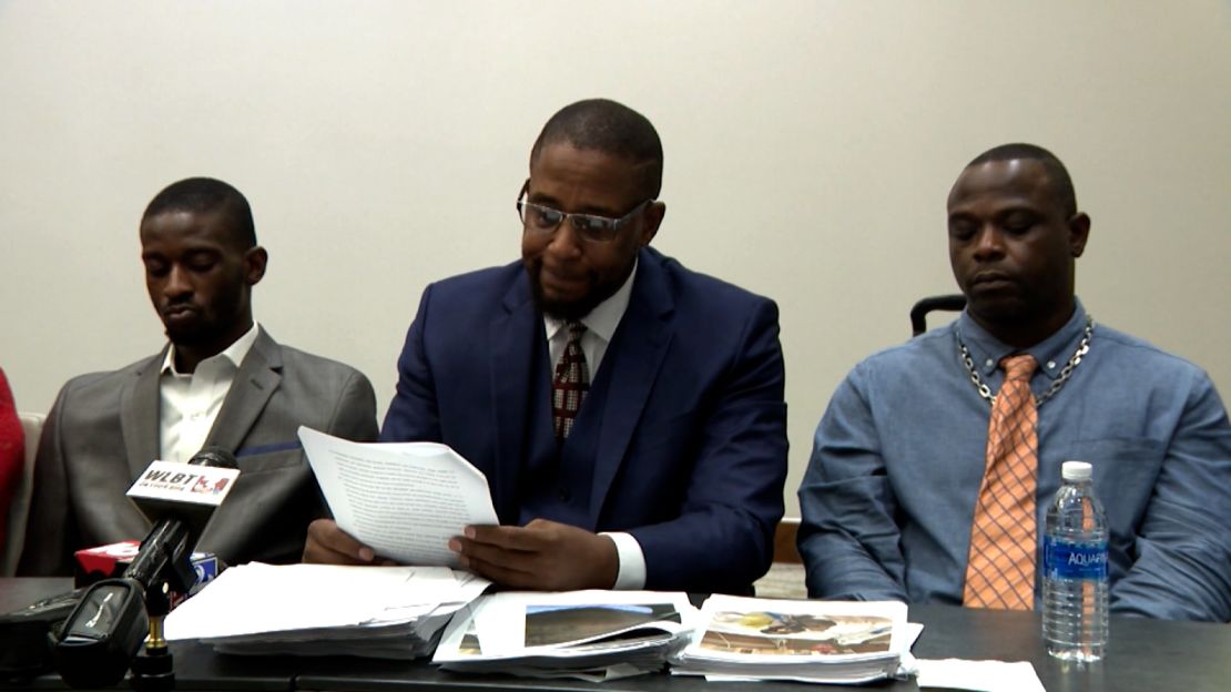 Michael Jenkins, left, attorney Malik Shabazz, center, and Eddie Parker are seen at a news conference on June 13.