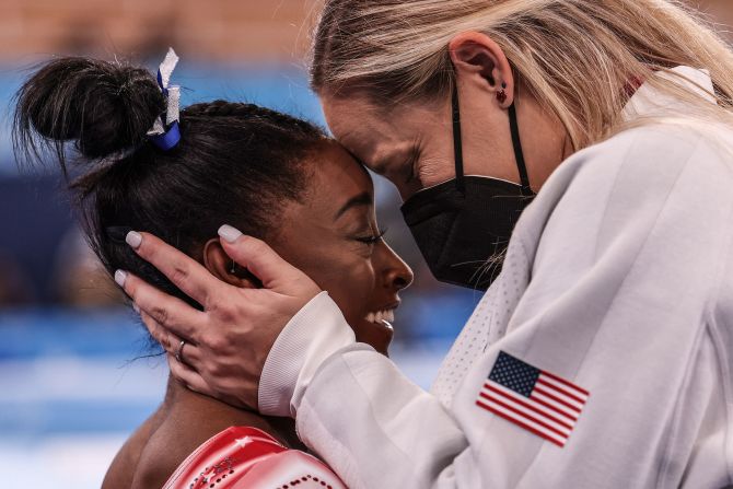 Biles is congratulated by coach Cecile Canqueteau-Landi after they realized Biles <a href="index.php?page=&url=https%3A%2F%2Fwww.cnn.com%2F2021%2F08%2F03%2Fsport%2Fgallery%2Fsimone-biles-return-balance-beam%2Findex.html" target="_blank">would win an Olympic bronze medal</a> in the balance beam final in July 2021. Biles had pulled out of several events earlier in Tokyo, citing mental health concerns. Specifically, she said she had "the twisties," a mental block in gymnastics in which competitors lose track of their positioning midair. Her bronze medal tied her with Shannon Miller for the most Olympic medals ever won by an American gymnast.