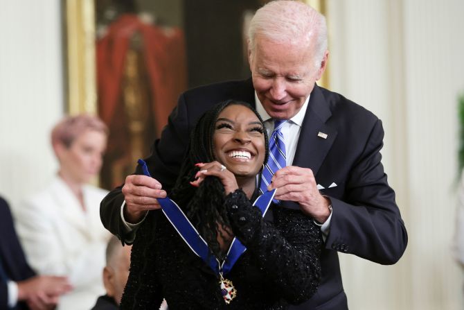 President Joe Biden awards Biles with the Presidential Medal of Freedom in July 2022. Biles, 25, became <a href="index.php?page=&url=https%3A%2F%2Fwww.cnn.com%2F2022%2F07%2F07%2Fpolitics%2Fbiden-presidential-medal-of-freedom%2Findex.html" target="_blank">the youngest person ever to receive the award</a>. "When she stands on the podium,we see what she is: absolute courage to turn personal pain into a greater purpose, to stand and speak up for those who cannot speak for themselves," Biden said.