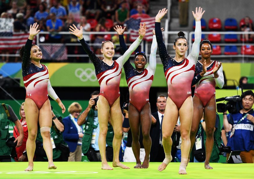 From left, US gymnasts Laurie Hernandez, Madison Kocian, Simone Biles, Aly Raisman and Gabby Douglas celebrate after winning gold in the team all-around at the 2016 Olympics.