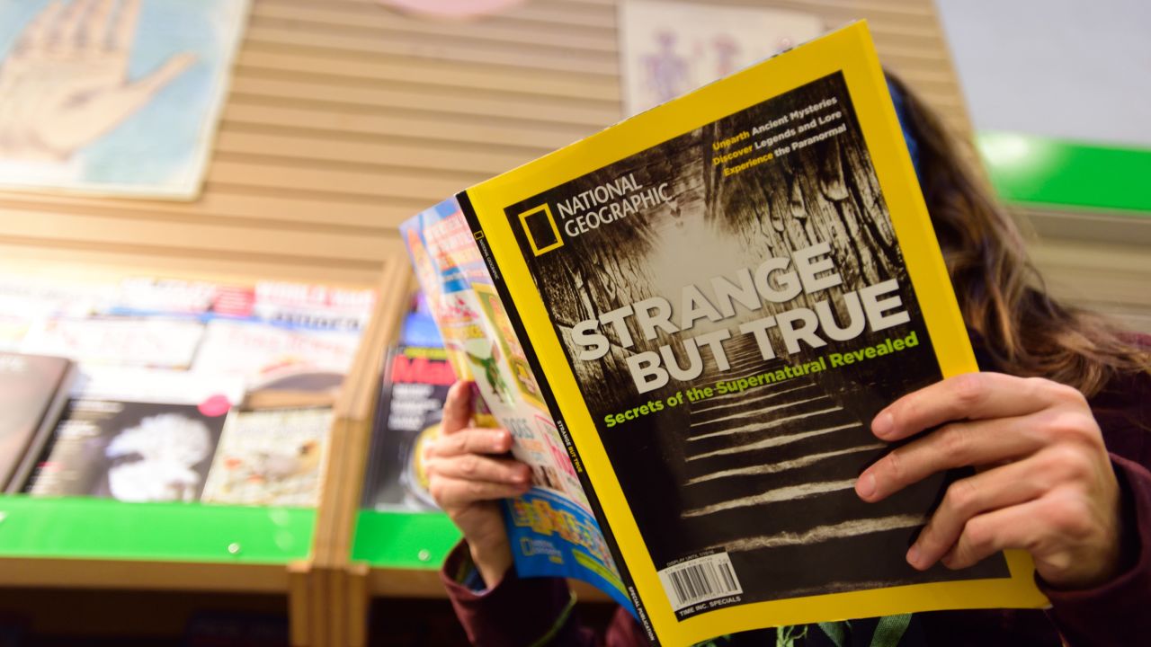 A woman reads the current issue of National Geographic at Powell's City of Books in Portland, Ore., on November 3, 2015.