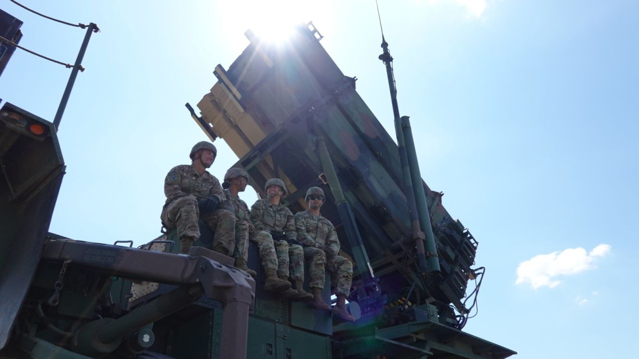 Servicemembers assinged to Bravo Battery, 5th Battalion, 7th Air Defense Artillery, 10th Army Air Missile Defense Command, rest on a Patriot missile launcher on Aug. 9 in Slovakia. 