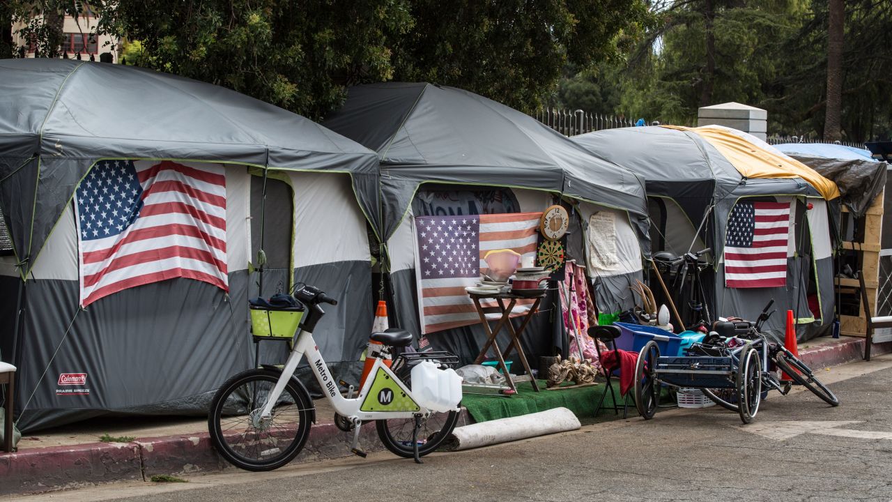 LOS ANGELES, CA - APRIL 22:  Homeless veterans are housed in 30 tents on a sidewalk along a busy San Vicente Boulevard outside the Veteran's Administration campus in West Los Angeles as viewed on April 22, 2021 in Los Angeles, California. During a 2020 count it was reported that there are an estimated 4,000 veterans living on the streets of Los Angeles. (Photo by George Rose/Getty Images)