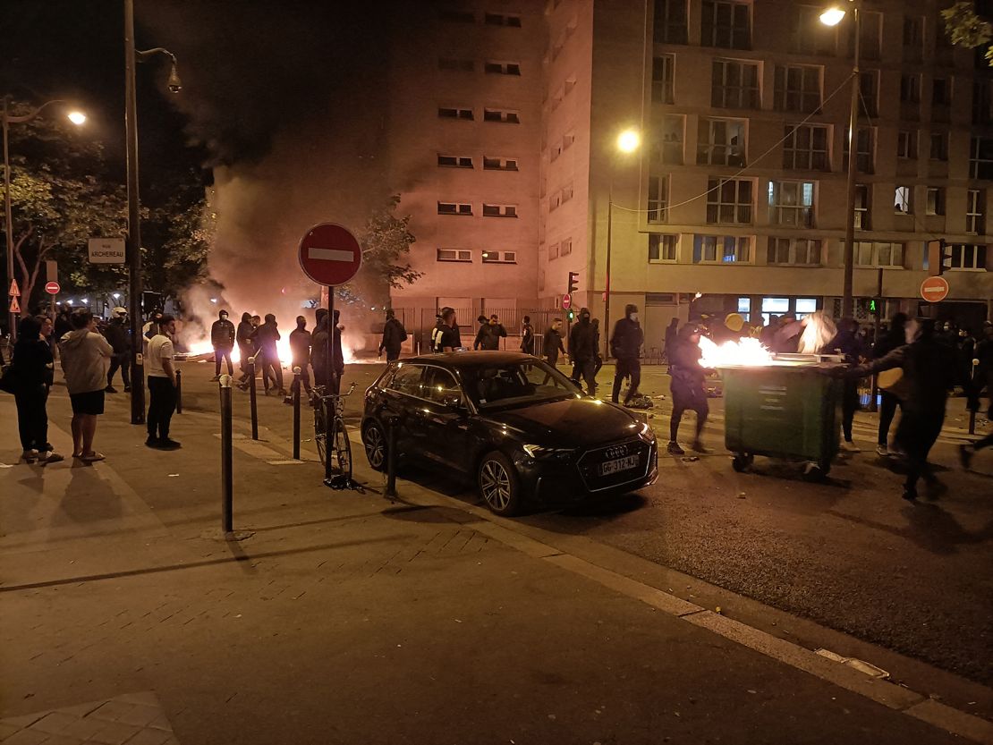 Protesters burn garbage bins and block a street during a protest in Paris on June 29.