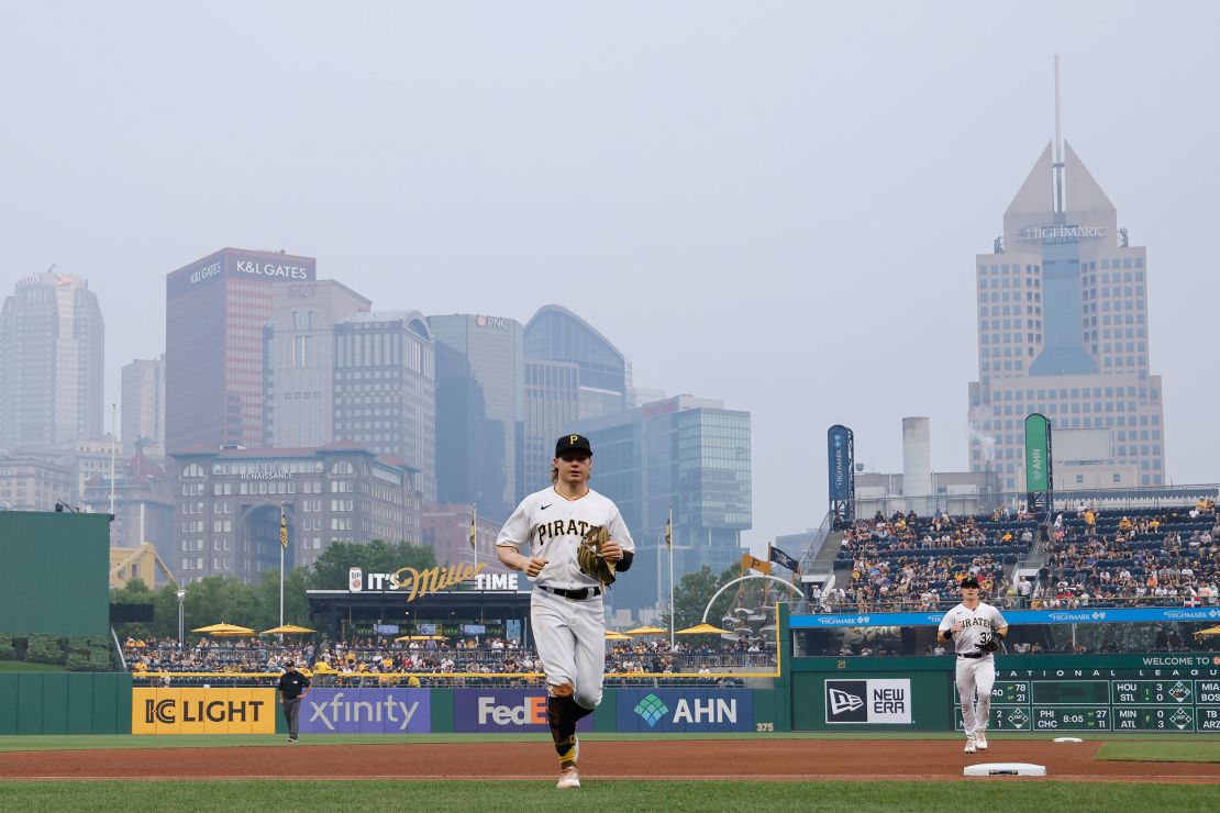 Pittsburgh Pirates play as smoke from wildfires in Canada descends on the downtown skyline in Pittsburgh on Wednesday.