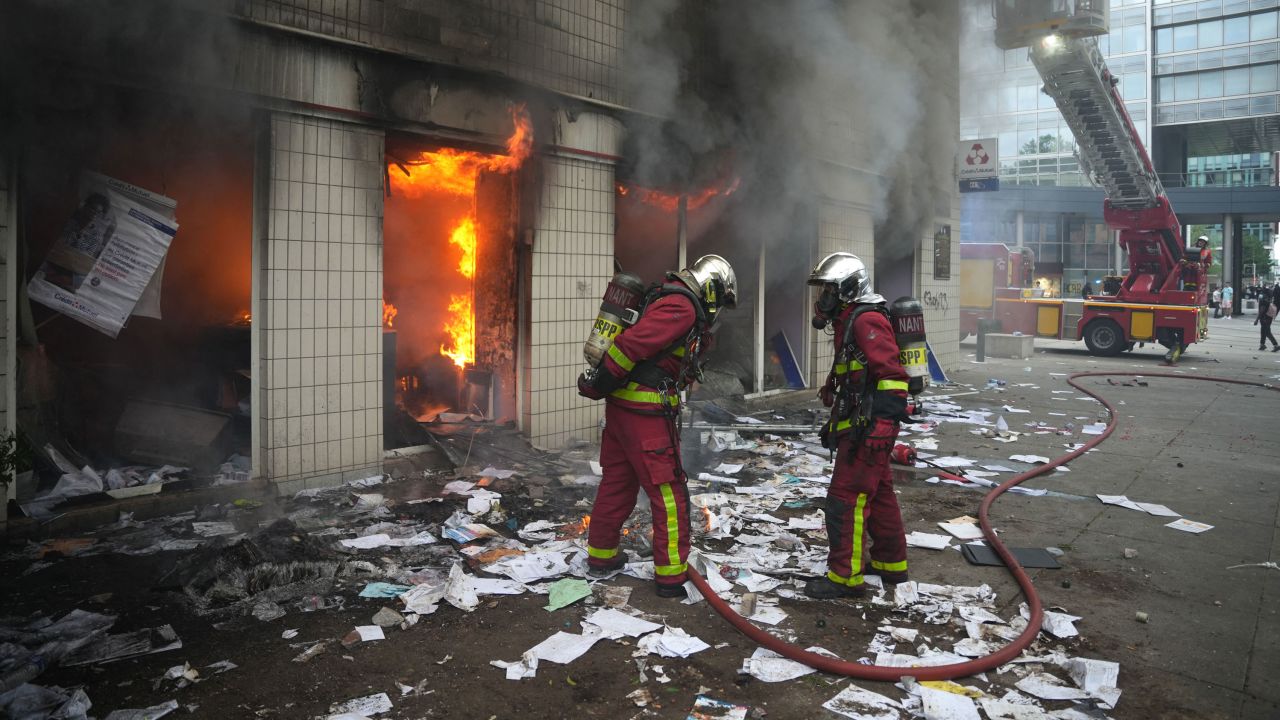 Firefighters extinguish a fire at an office of French bank Credit Mutuel in the Parisian suburb of Nanterre on June 29, 2023. 
