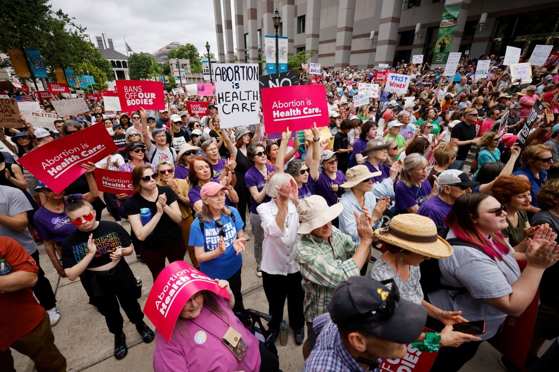 Abortion rights supporters display protest signs as they gather to witness North Carolina Governor Roy Cooper vetoing the SB20 legislation limiting most abortions to the first trimester of pregnancy, a sharp drop from the state's current limit of 20 weeks gestation, in Raleigh, North Carolina, U.S. May 13, 2023. REUTERS/Jonathan Drake