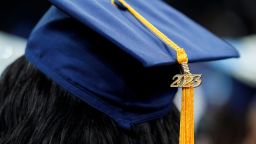 A tassel with 2023 on it rests on a graduation cap as students walk in a procession for Howard University's commencement in Washington, Saturday, May 13, 2023. 
