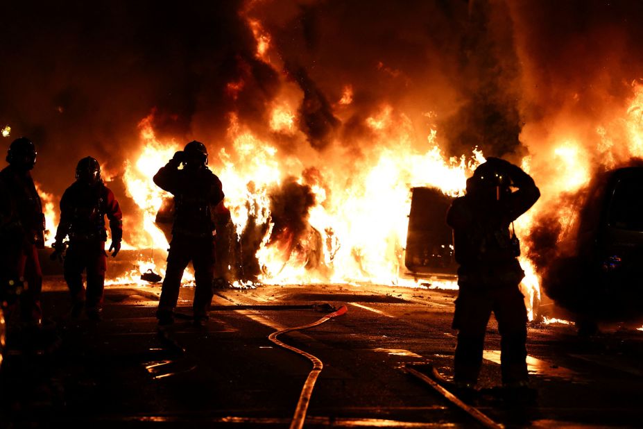 Firefighters extinguish burning vehicles during clashes in Nanterre on Wednesday, June 28.