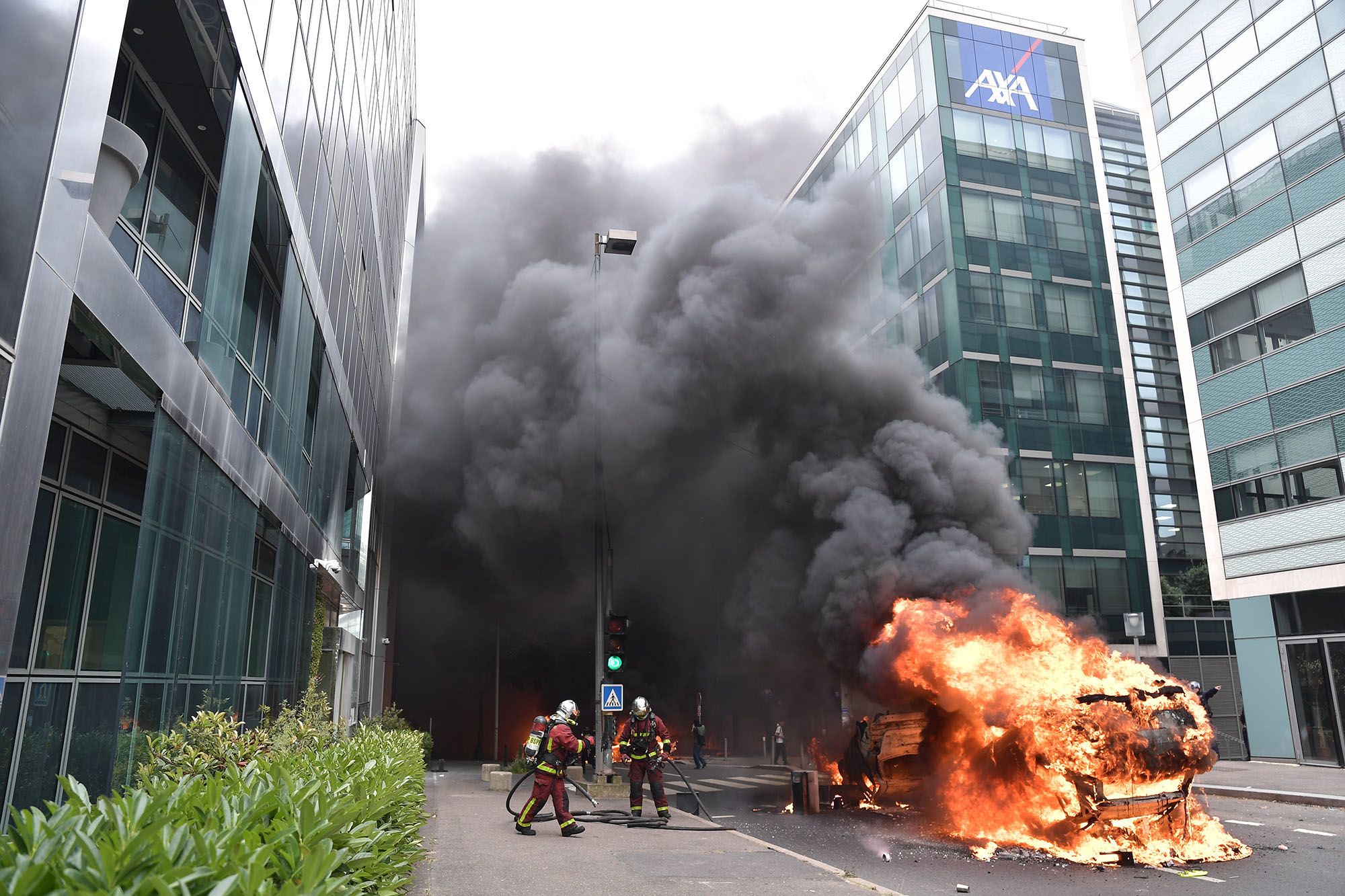 Firefighters try to extinguish burning cars in Paris on June 29.