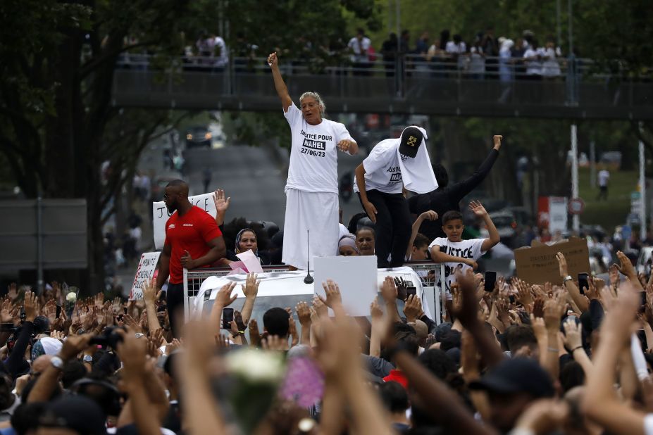 Mounia, the mother of Nahel Merzouk, gestures as she stands on a truck during a march in Nanterre on June 29.