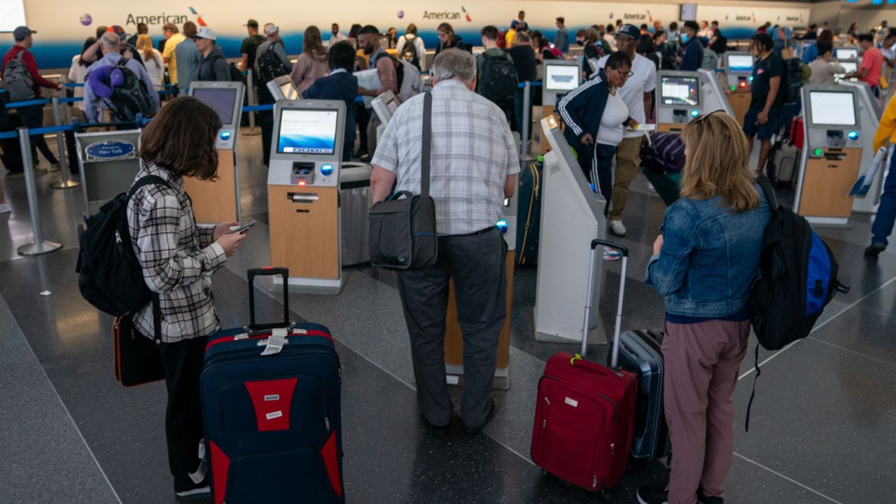 Passengers weave through JFK International airport on Friday, which is expected to be the busiest day for air travel since the start of the pandemic. 