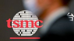 A man walks past a logo of Taiwan Semiconductor Manufacturing Company (TSMC) during a shareholders' meeting in Hsinchu on June 6, 2023. 