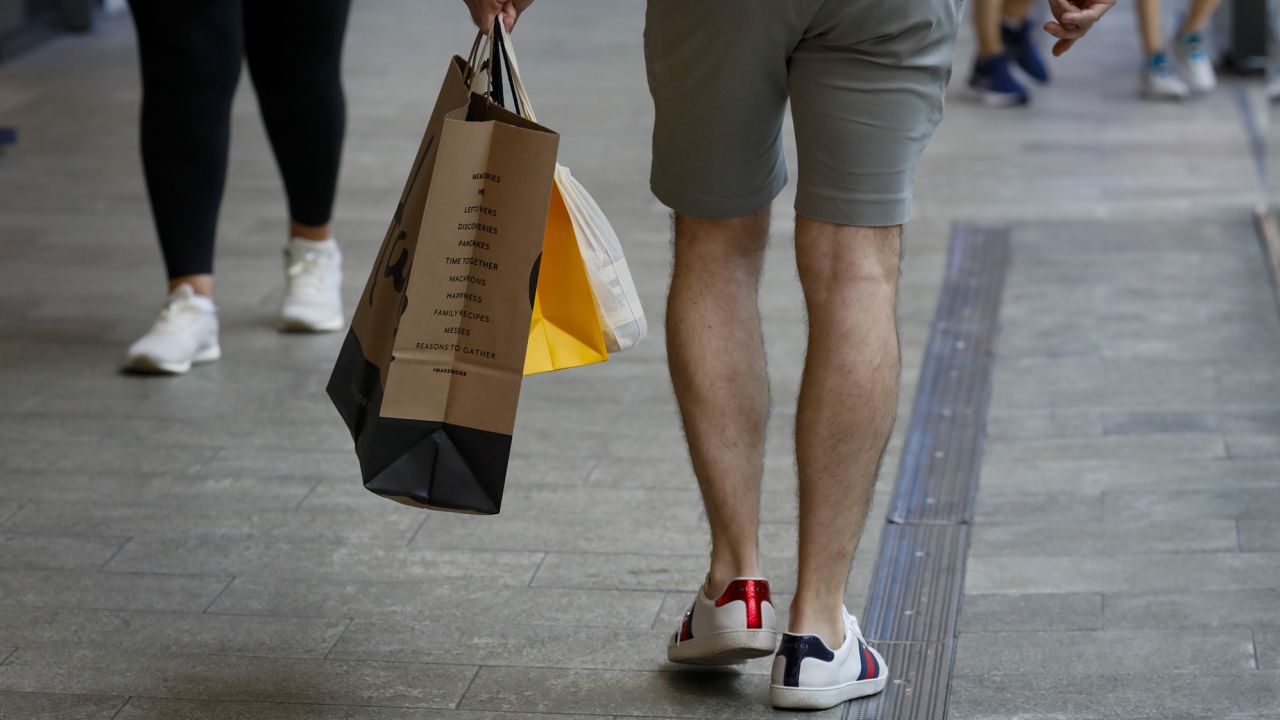 A shopper carries retail bags in Miami, Florida, on Wednesday, June 14, 2023. 