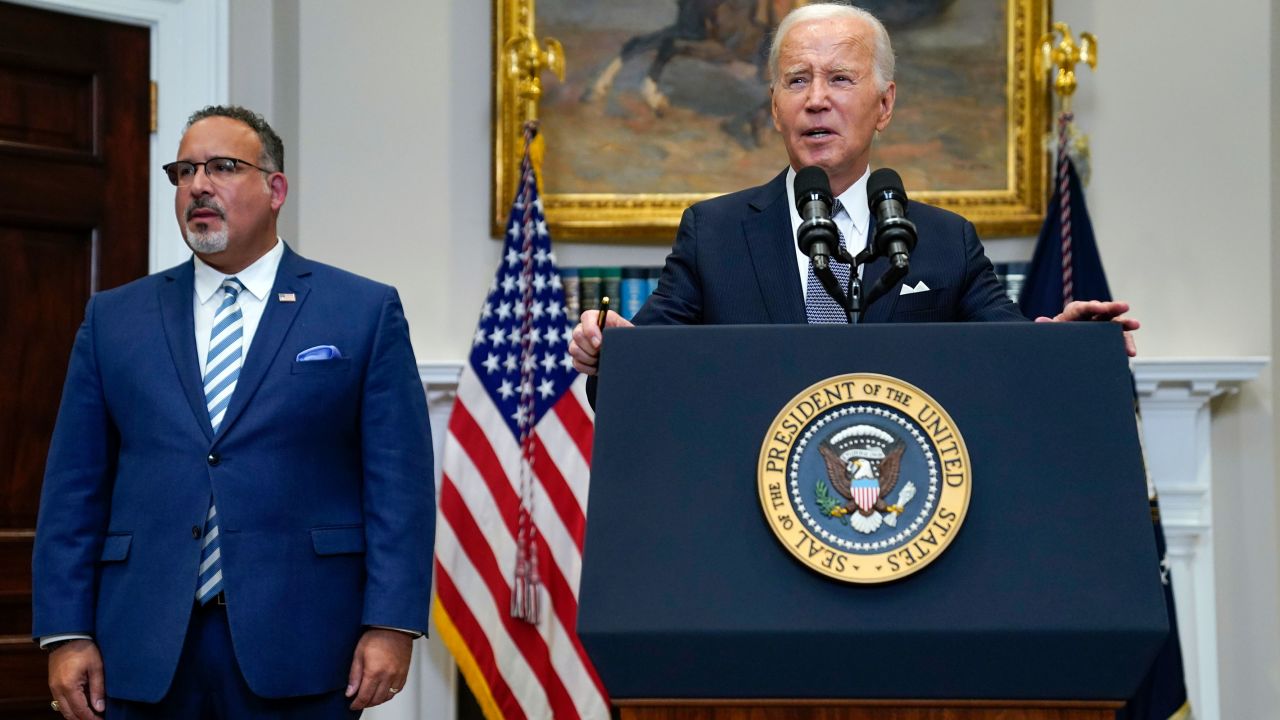 President Joe Biden speaks in the Roosevelt Room of the White House, Friday, June 30, 2023, in Washington, after Supreme Court rulings issuing a major decision that impacts gay rights and striking down Biden's student loan forgiveness plan. Education Secretary Miguel Cardona listens at left.
