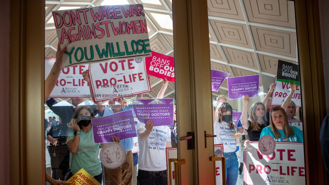 Demonstrators hold signs as North Carolina Republican lawmakers hold a vote to override Democratic Governor Roy Cooper's veto of a bill that would ban most abortions in the state after 12 weeks, in Raleigh, North Carolina, U.S. May 16, 2023.