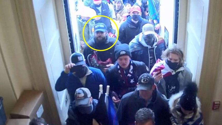 At approximately 2:33 p.m., the Upper West Terrace door to the Capitol was breached by multiple people. Shortly thereafter, at approximately 2:38 p.m., TARANTO entered the breached door. Surveillance footage depicts TARANTO entering amongst a mob who were streaming into the building. TARANTO was wearing a dark all-weather style jacket with a gray hood.