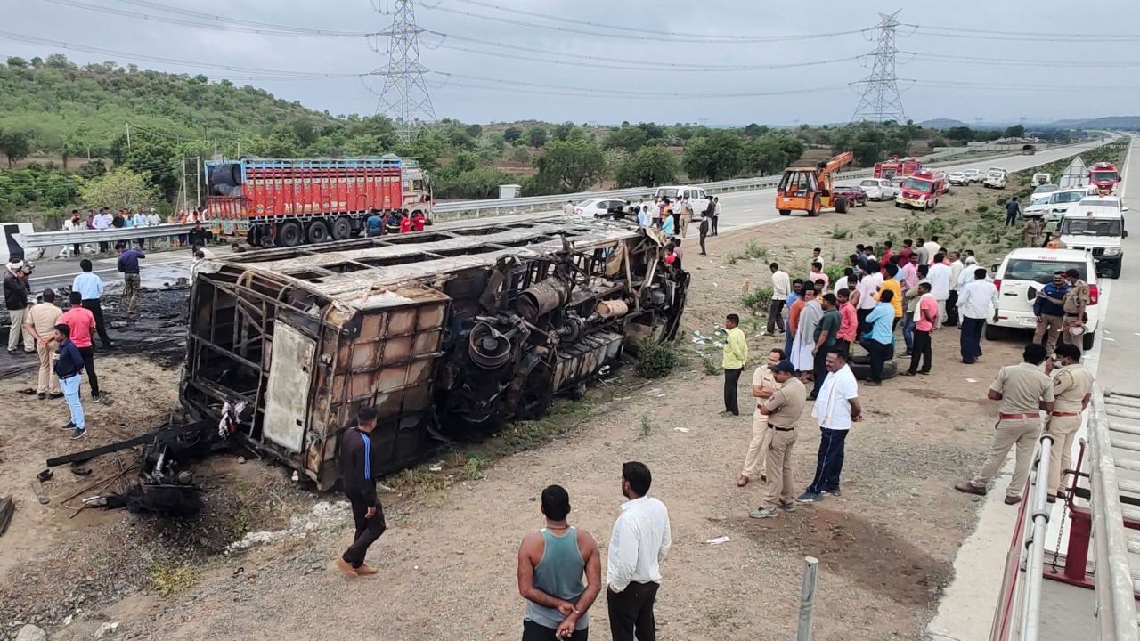 People gather around the wreckage of a bus that caught fire along the Samruddhi Expressway near Sindkhed Raja in Buldhana district of Maharashtra state on July 1, 2023. At least 25 people were killed and eight others injured after a bus caught fire overnight on an expressway in India's Maharashtra state, police said on July 1. (Photo by Gajanan MEHETRE / AFP) (Photo by GAJANAN MEHETRE/AFP via Getty Images)