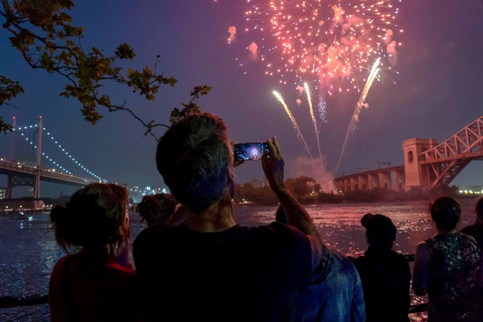 Spectators watch fireworks in the Queens borough of New York City on Thursday.