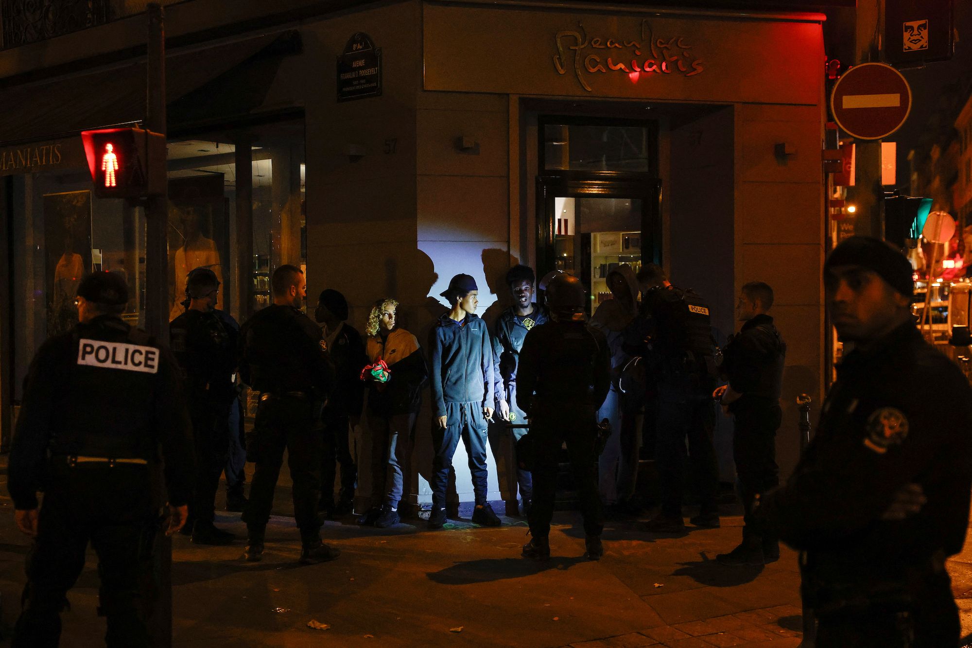 Police stop a group of young people in the Champs-Élysées area of Paris on July 2.