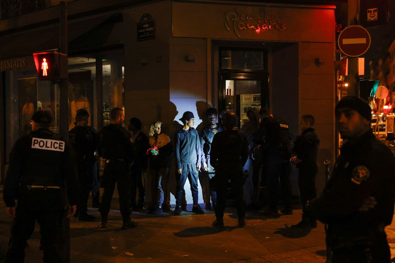 Police stop a group of young people in the Champs-Élysées area in Paris on July 2.