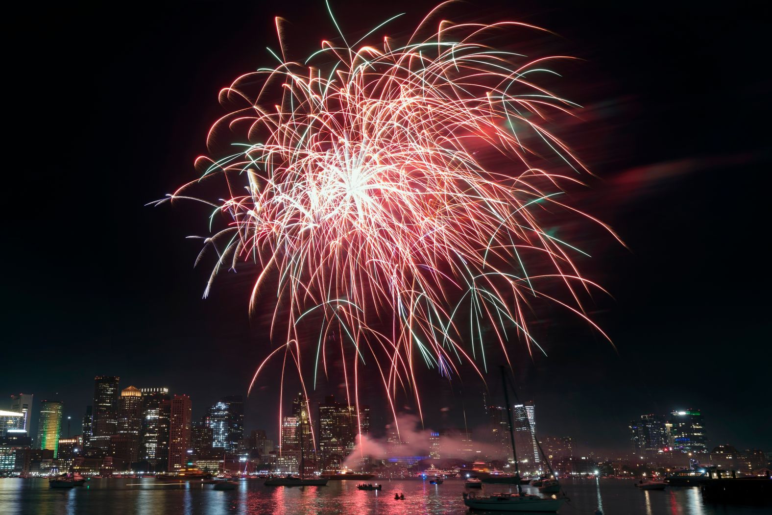 Fireworks explode over Boston Harbor on Saturday.