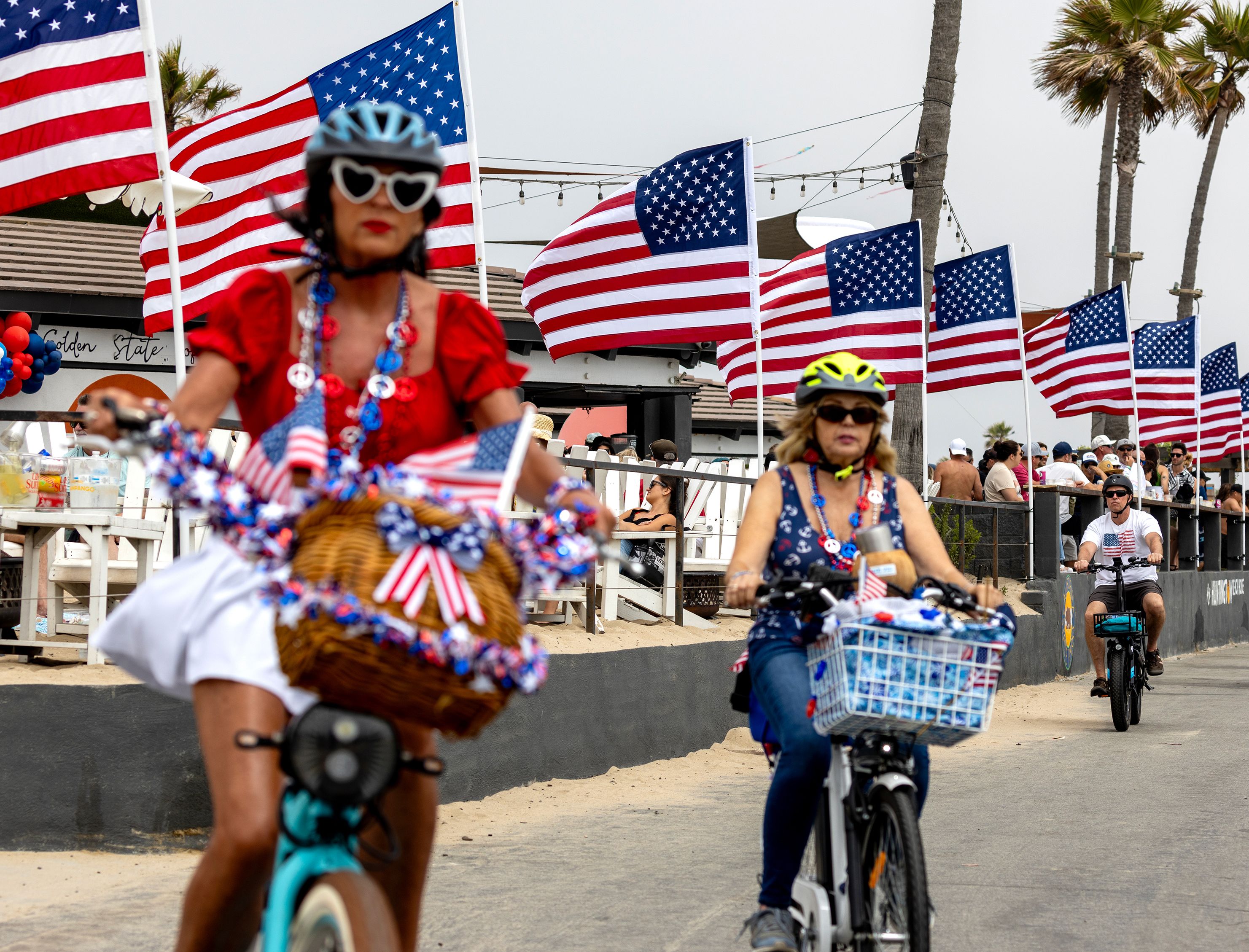 People ride bikes in Huntington Beach, California, on Saturday.