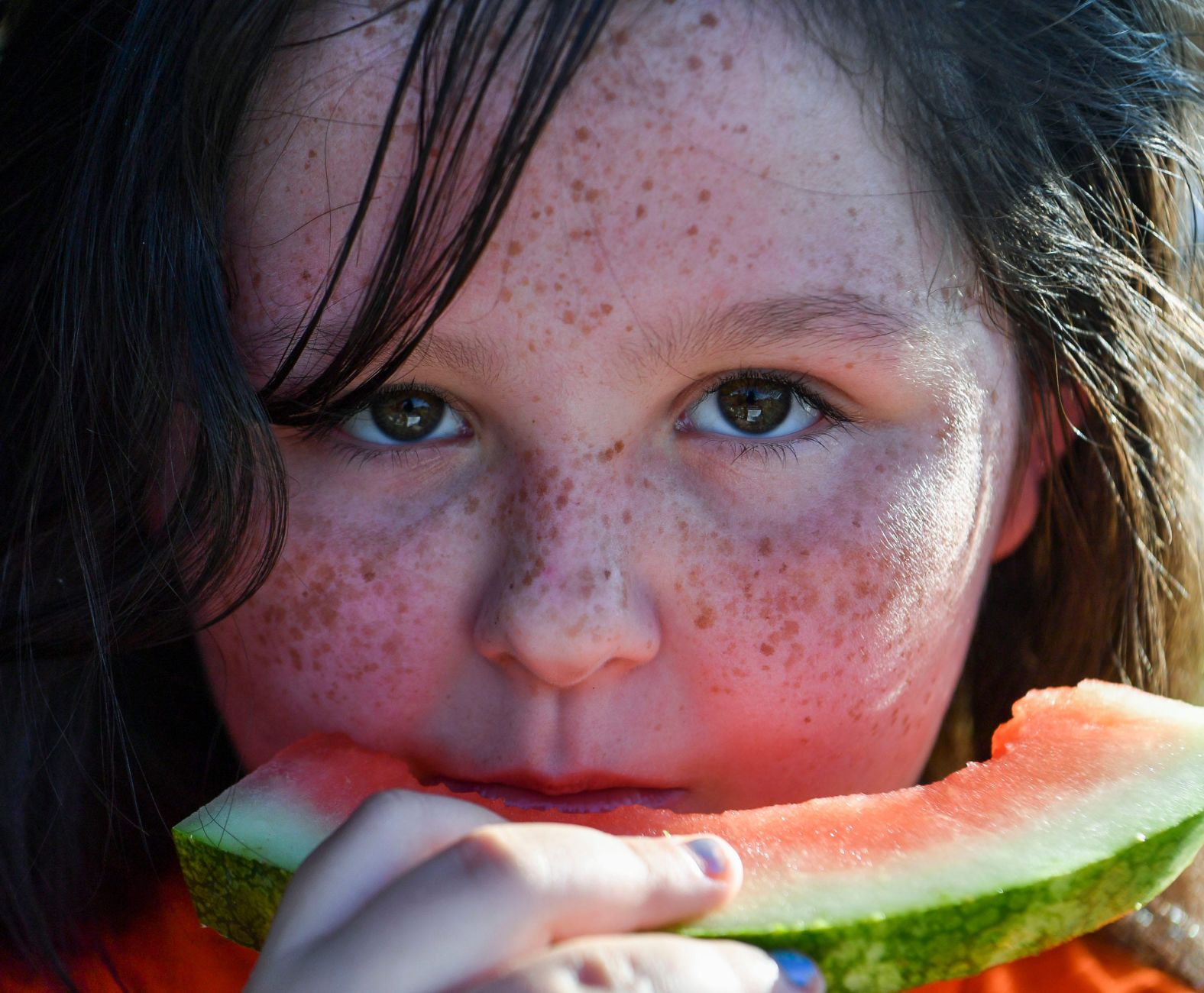 A child eats watermelon at a Fourth of July celebration in Indiantown, Florida, on Saturday. 