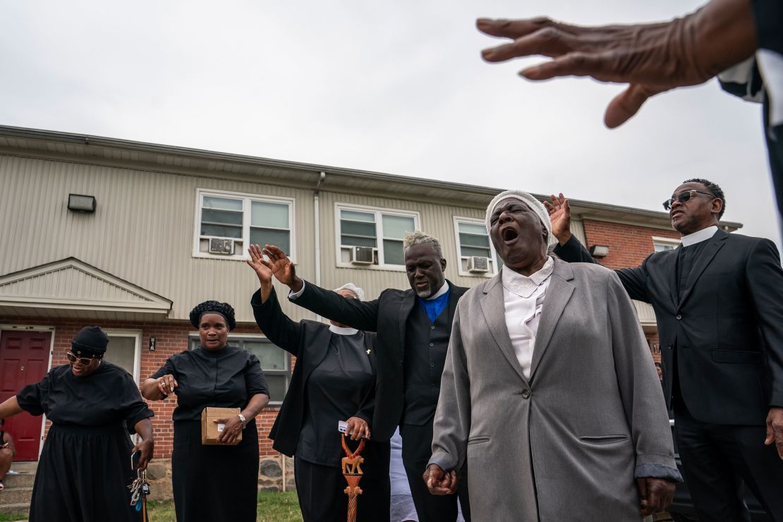 Members of the Kingdom Life Church pray at the site of a mass shooting in the Brooklyn Homes neighborhood on July 2, 2023.