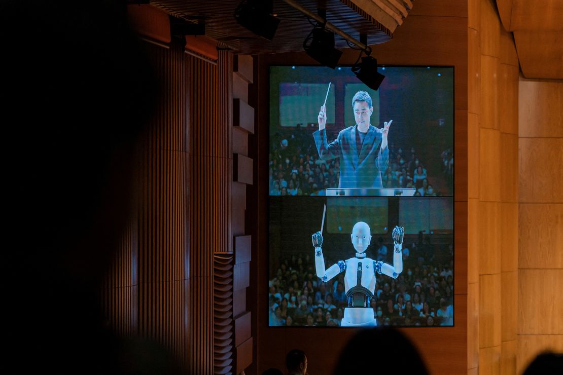 An android robot, EveR 6, is seen on a screen as it takes the conductor's podium to lead a performance by South Korea's national orchestra with human conductor Choi Soo-yeoul, in Seoul, South Korea, June 30, 2023, in this handout picture. National Theater of Korea/Handout via REUTERS    THIS IMAGE HAS BEEN SUPPLIED BY A THIRD PARTY. MANDATORY CREDIT. NO RESALES. NO ARCHIVES