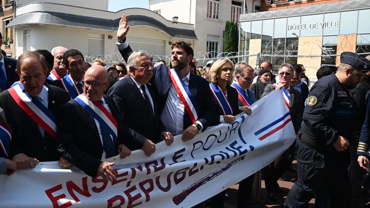 Mayor Vincent Jeanbrun waved to supporters during the march.