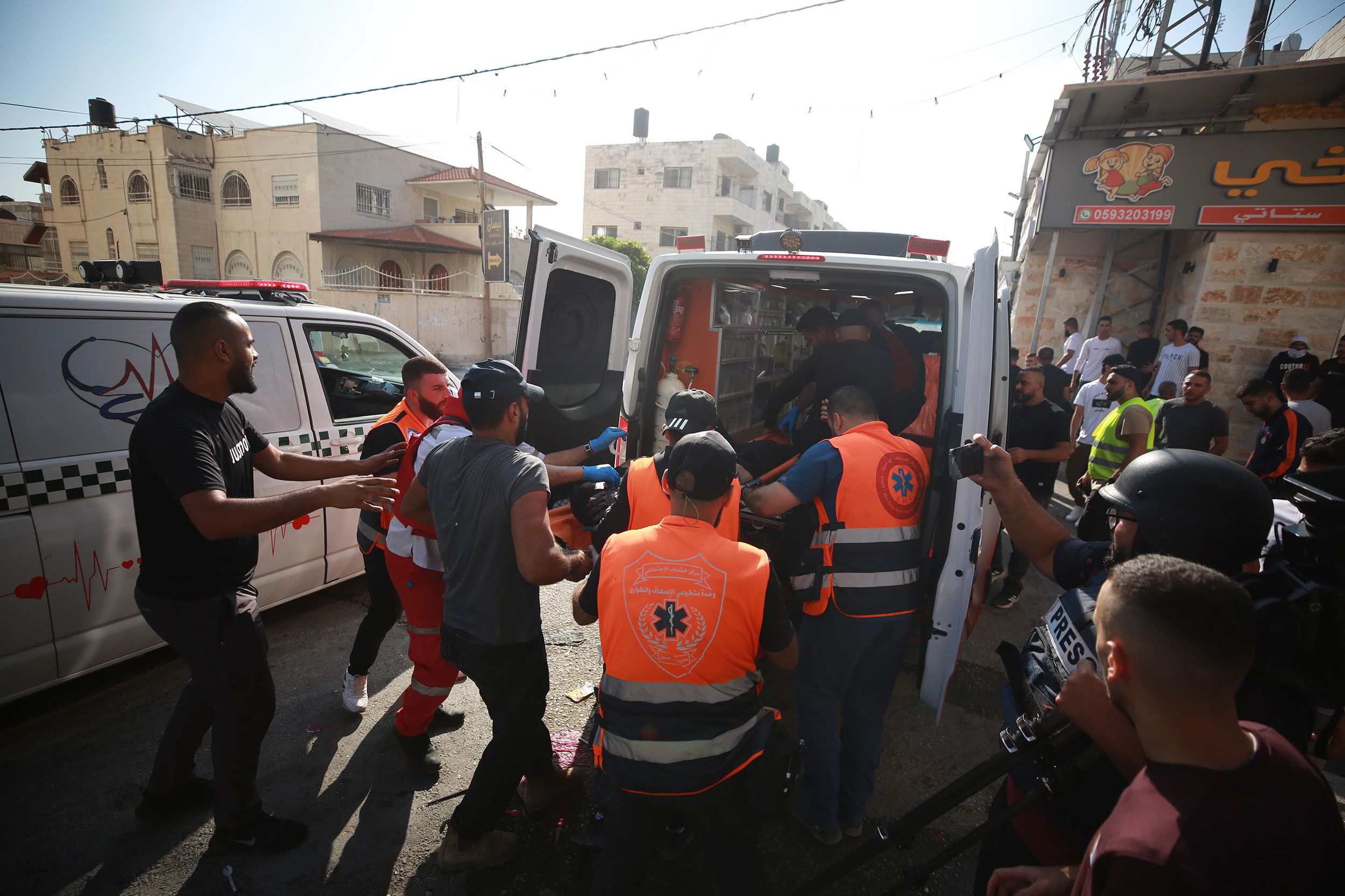 Wounded people are transferred into an ambulance for hospital treatment in Jenin on Sunday.