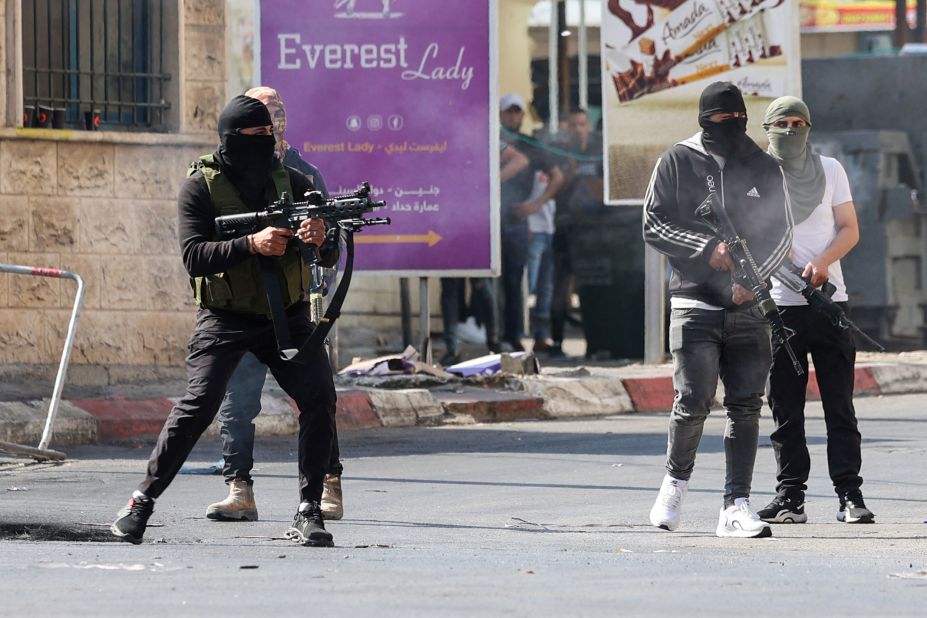 Palestinian militants take up position during a confrontation with Israeli forces in Jenin on Monday.