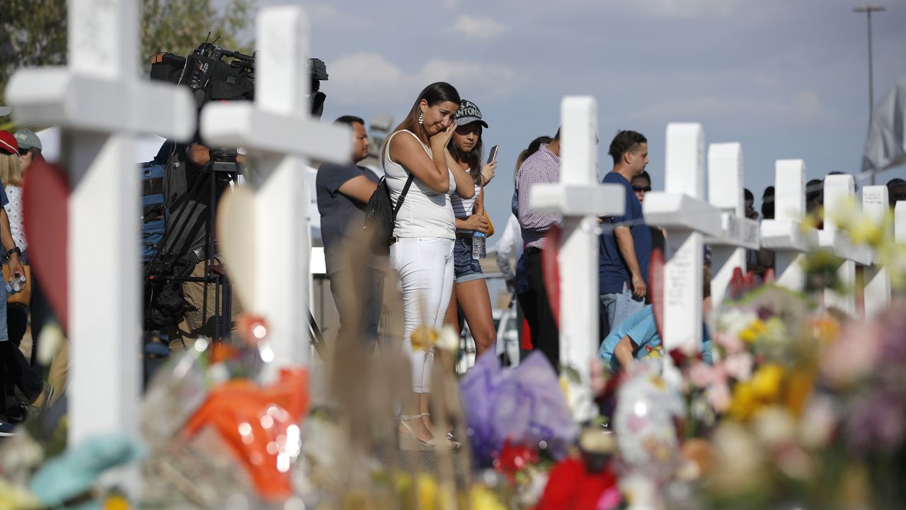 People visit a makeshift memorial at the site of the August 2019 shooting in El Paso, Texas. 