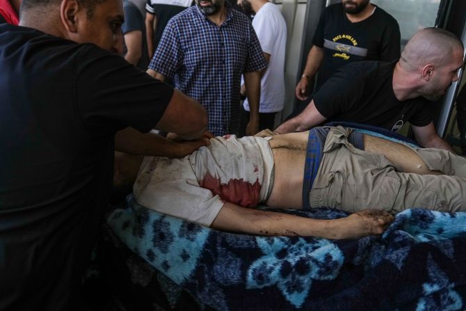 An injured Palestinian is carried into a hospital Monday in Jenin.