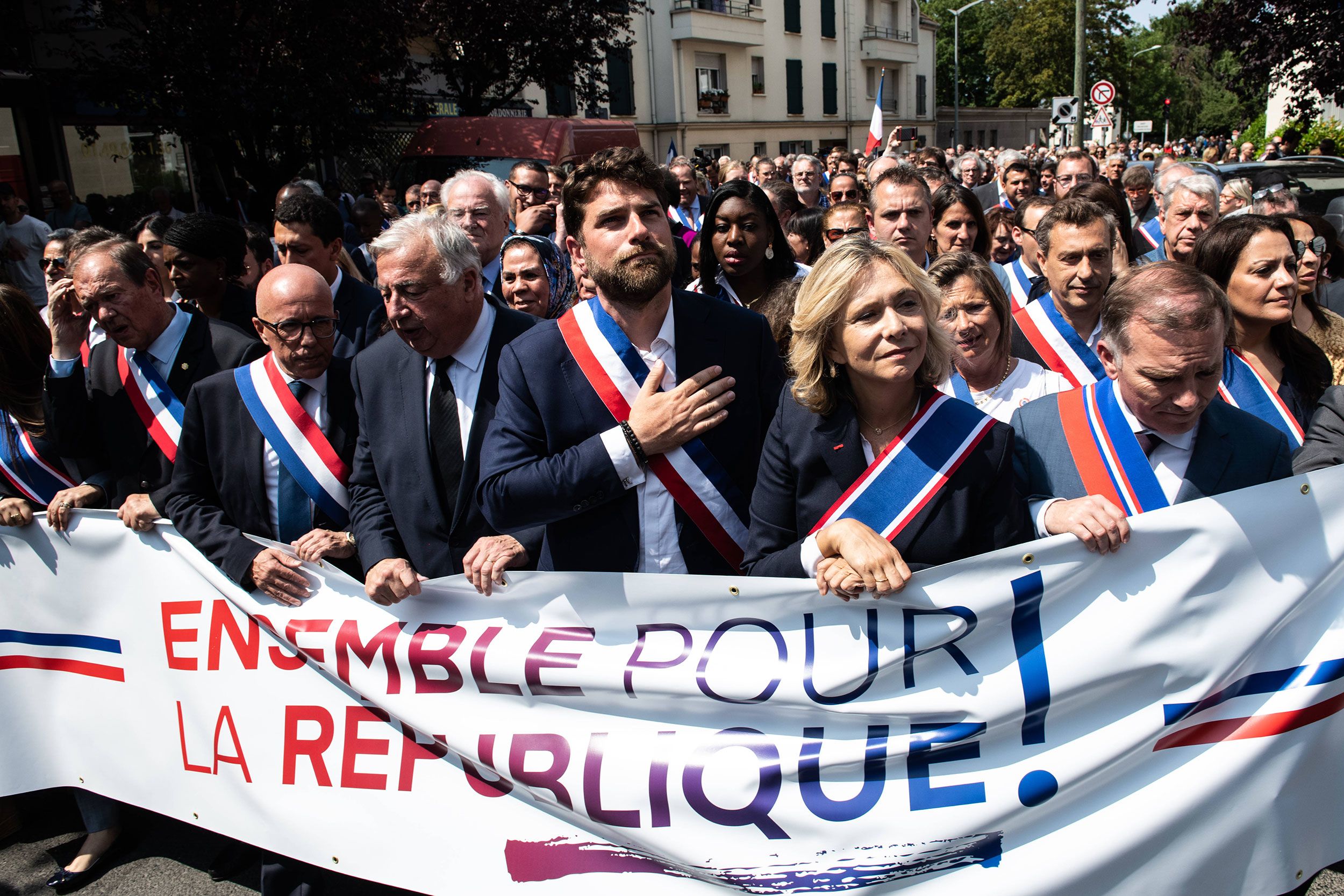 A large crowd marches with Jeanbrun to show their support for him on Monday, July 3.