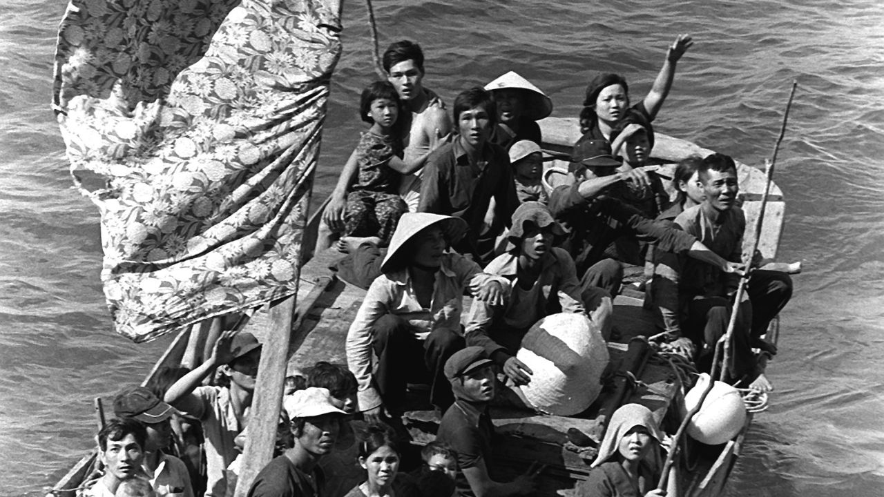 35 Vietnamese refugees wait to be taken aboard the amphibious command ship USS BLUE RIDGE (LCC-19).  They are being rescued from a 35 foot fishing boat 350 miles northeast of Cam Ranh Bay, Vietnam, after spending eight days at sea.