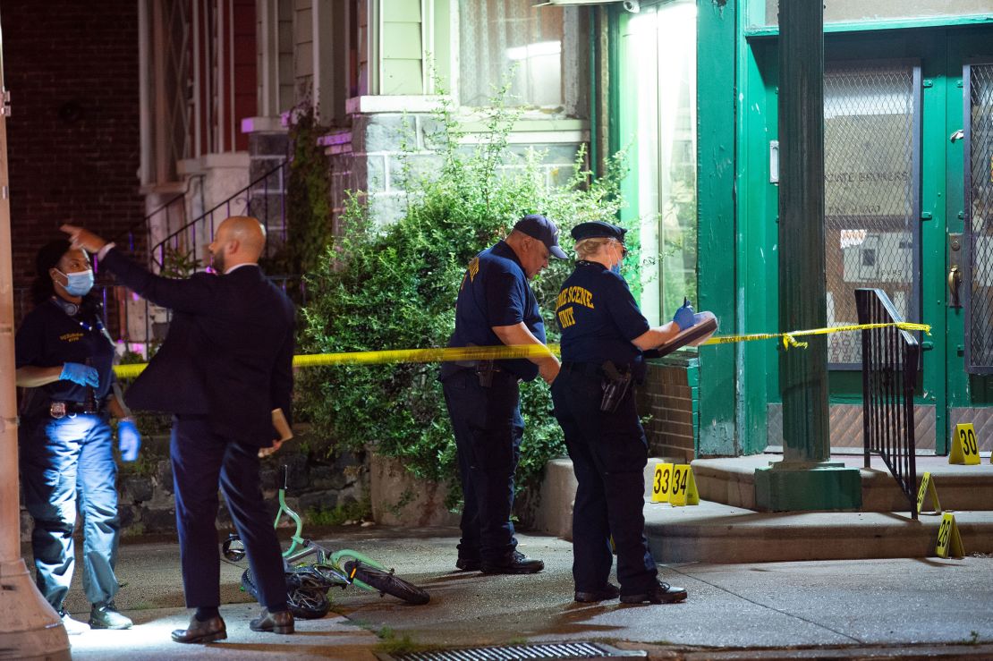 Investigators are seen at the site of Monday's mass shooting.