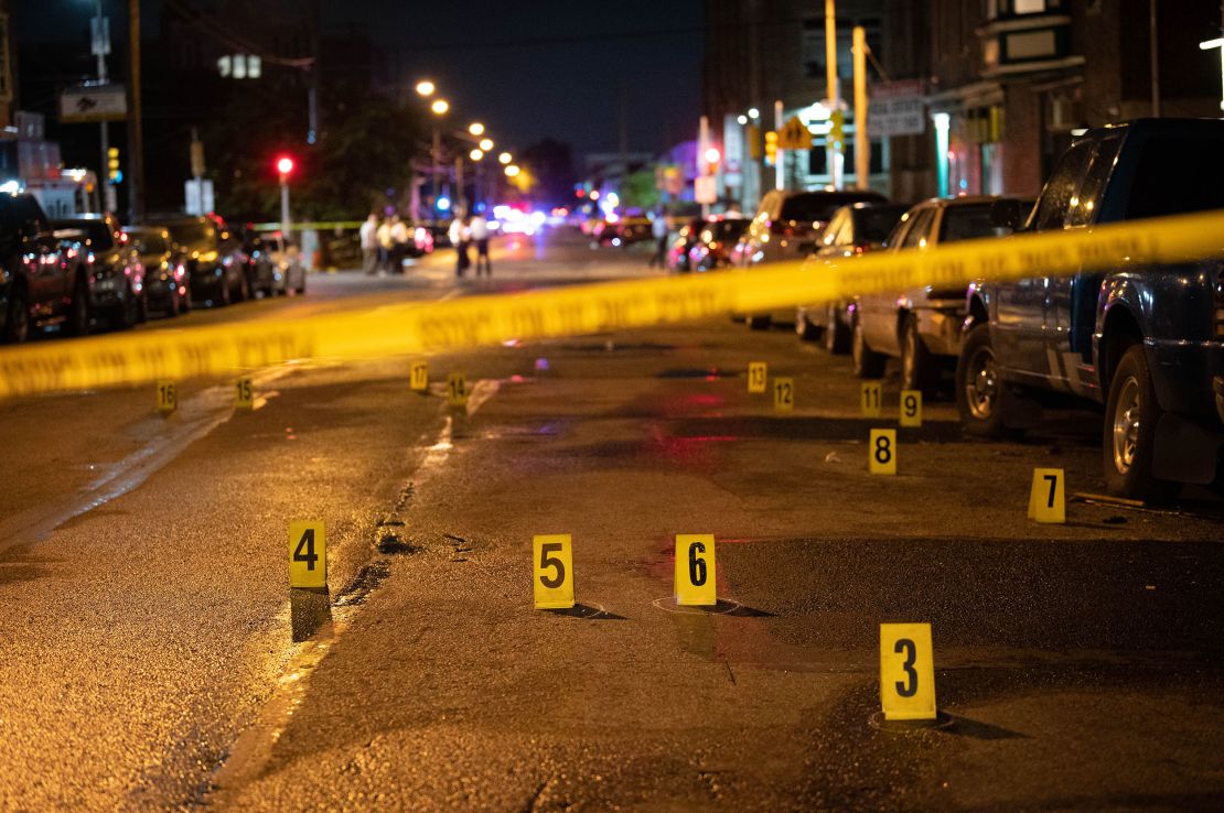 Police work the scene of a mass shooting Monday in the Kingsessing neighborhood of Philadelphia.